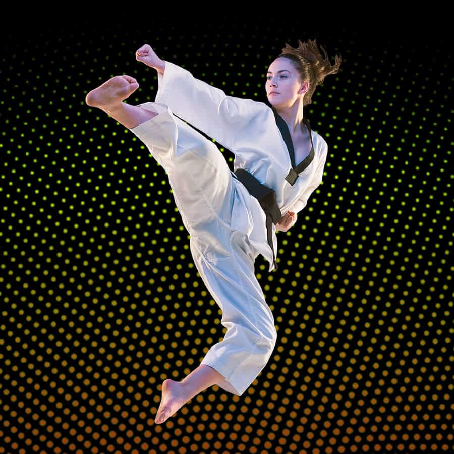 Martial Arts Lessons for Adults in Seattle WA - Girl Black Belt Jumping High Kick